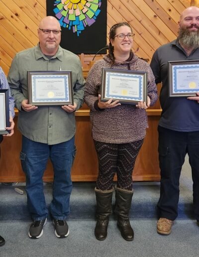 5 people who graduated from Supernatural Ministries Training Institute holding their diplomas.